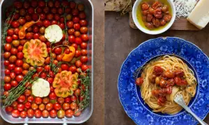 En ugnsform fylld med körsbärstomater, vitlök och örter. Bredvid en blå tallrik med spaghetti och **confiterade tomater**.