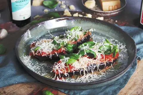 Aubergine i ugn, toppad med tomatsås, basilika och rikligt med riven ost. En läcker och smakrik rätt.